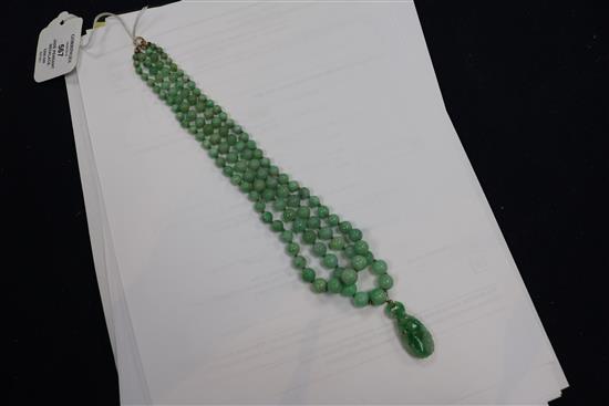 A double strand graduated jadeite bead necklace with carved jadeite pendant, pendant 29mm.